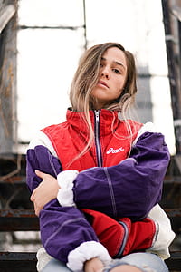 selective focus photograph of woman in red and purple ASICS zip-up jacket thumbnail
