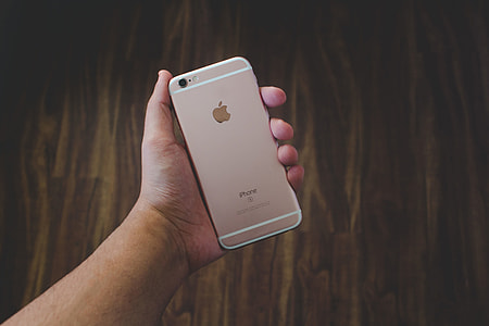 Person holding an iPhone mobile smartphone in their hand thumbnail