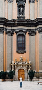 woman standing infront cathedral's facade thumbnail