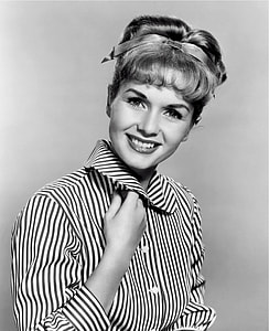 smiling woman in striped long-sleeved shirt black and white photography thumbnail