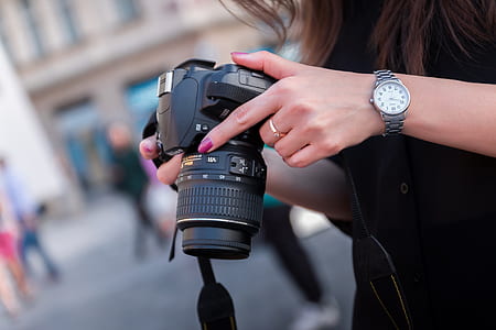 Woman Holding Black Dslr Camera thumbnail