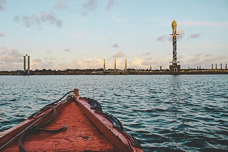 brown wooden canoe at beach during daytime thumbnail
