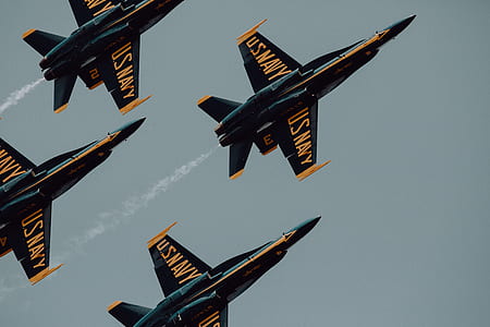 four orange-and-black U.S. Navy fighter jets flying thumbnail
