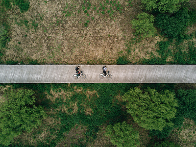 two people riding bike on bridge thumbnail
