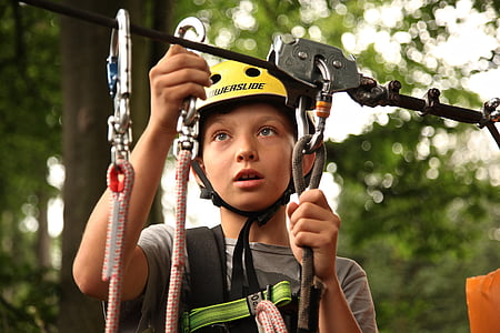 boy wears white cycling helmet and holds ropes thumbnail