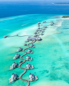 Aerial Photography of Island With Cottages Surrounded With Water thumbnail