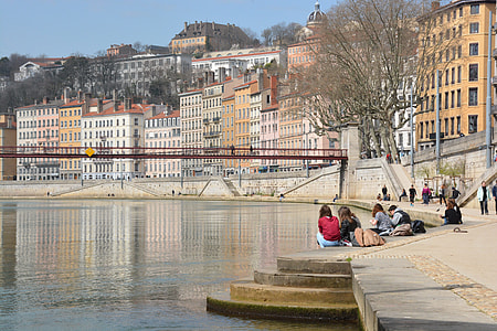 group of women sitting in front of body of water thumbnail