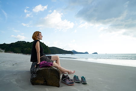 woman in black top sitting on bench thumbnail