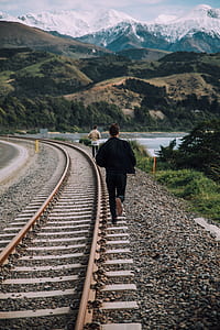 man walking on trail rail thumbnail