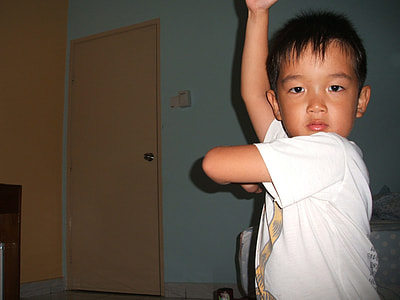 boy standing on mattress inside room thumbnail