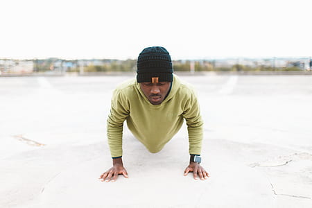 selective focus photography of man doing push ups at daytime thumbnail