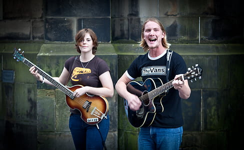 man and woman playing guitars thumbnail