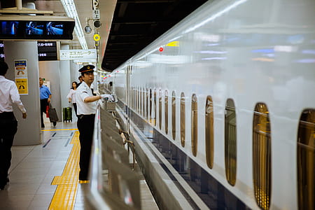man standing near train thumbnail