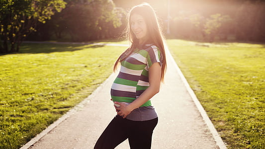 portrait photography of pregnant woman standing in the middle of road thumbnail