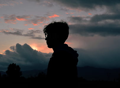 silhouette of man standing near tree thumbnail