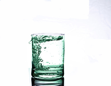 clear drinking glass with full of green liquid in it thumbnail
