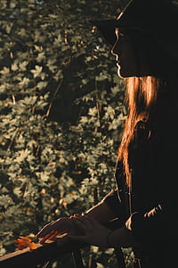 Woman Standing While Wearing Black Hat thumbnail
