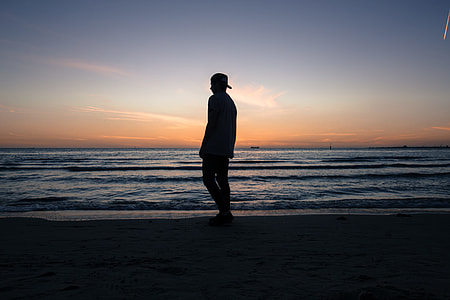 silhouette of person near ocean thumbnail