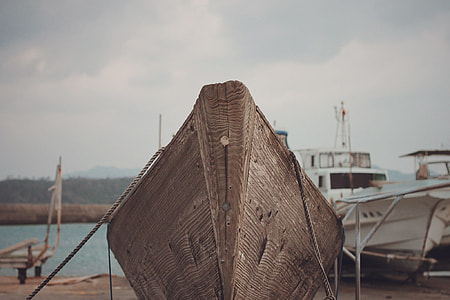 brown boat near yacht thumbnail