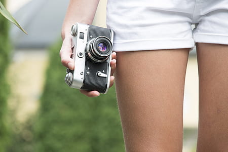 person holding mirrorless camera thumbnail
