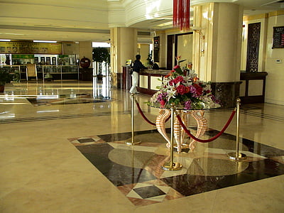 assorted flowers bouquet centerpiece on clear glass coffee table beside stanchions near person beside counter desk thumbnail