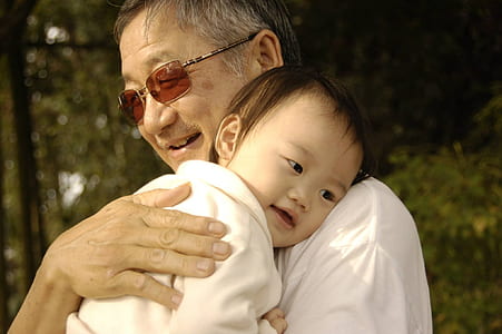 man carrying baby thumbnail