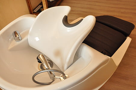 white shampoo chair on brown wooden surface thumbnail
