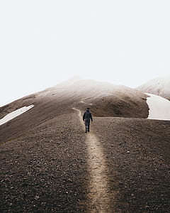 person walks on pathway in hill top thumbnail