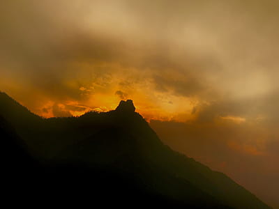 silhouette photo of mountain during golden hour thumbnail