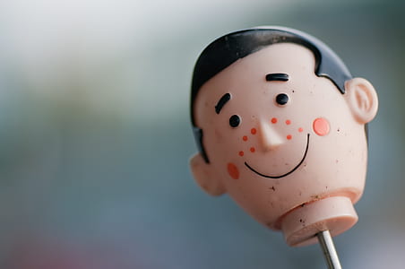 selective focus photography of male head toy thumbnail