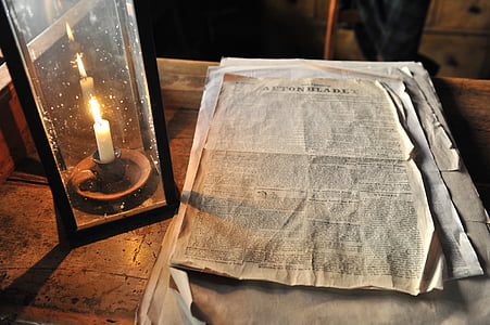 book page on table near candle thumbnail