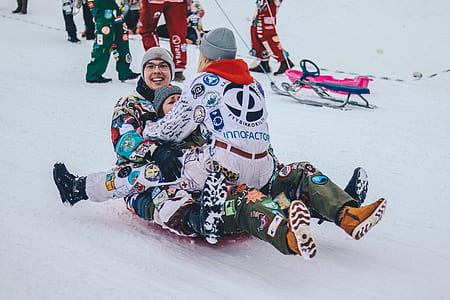 three people riding snow sled thumbnail