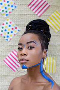 Woman Wearing Silver-colored Hoop Earrings thumbnail