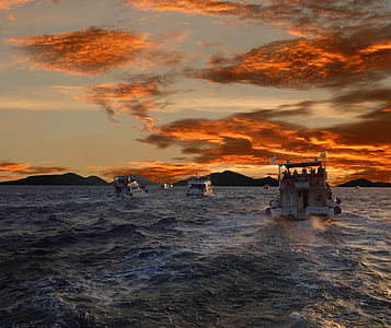 boat under clouds at daytime thumbnail