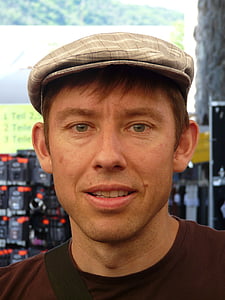 photo of man with gray hat and maroon crew-neck top thumbnail
