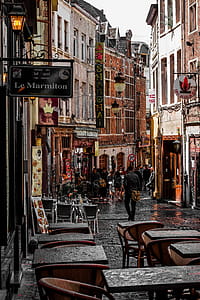 Man Walking on Alley in Between Houses thumbnail