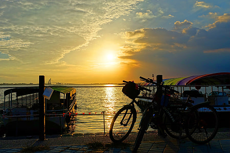 two bicycles parked on seashore thumbnail