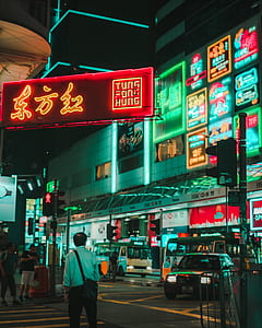 man walking on the street during night time thumbnail