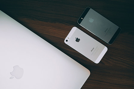 Laptop and iPhone mobile smartphone on desk thumbnail