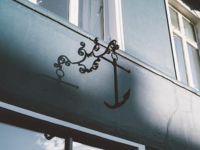 anchor hanging decor on gray painted wall thumbnail