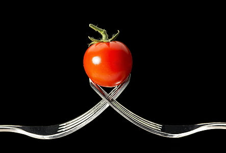 photo of tomato between the tips of two forks thumbnail