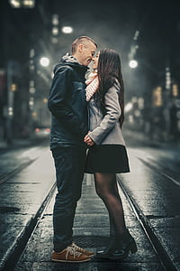 man and woman about to kiss on road at night thumbnail