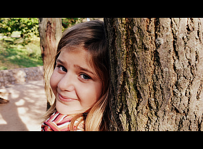 girl leaning on brown tree thumbnail