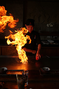 chef putting oil on flaming pan thumbnail
