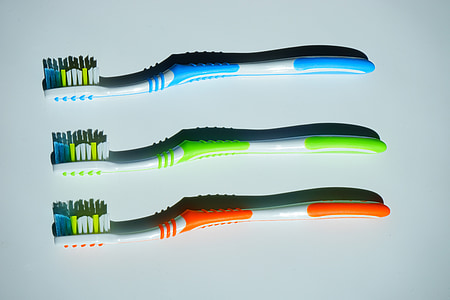 three assorted-color toothbrushes thumbnail