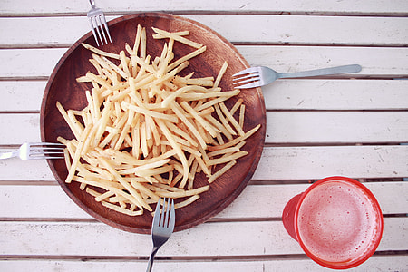 four stainless steel fork, round plate and french fries thumbnail