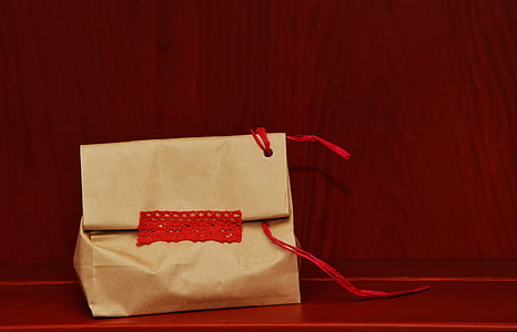 beige paper bag on red surface thumbnail