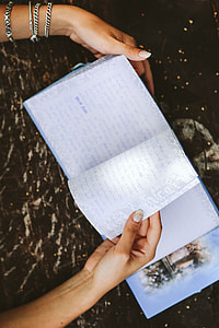 Woman reading a diary by the table thumbnail