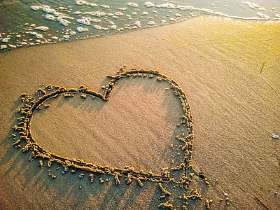 heart sand art on seashore thumbnail