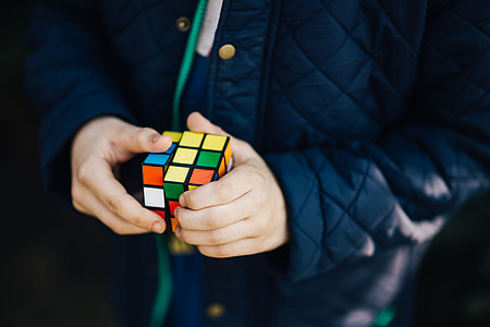 Boy in a blue jacket holding things thumbnail